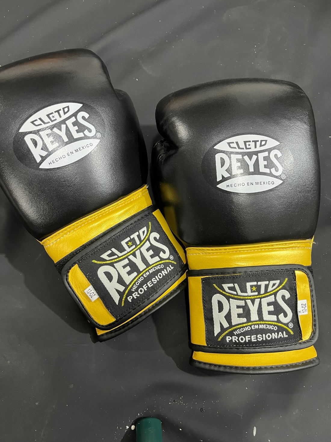 Pair of black and gold professional boxing gloves