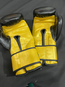 Black and gold professional boxing gloves palm and wrist view