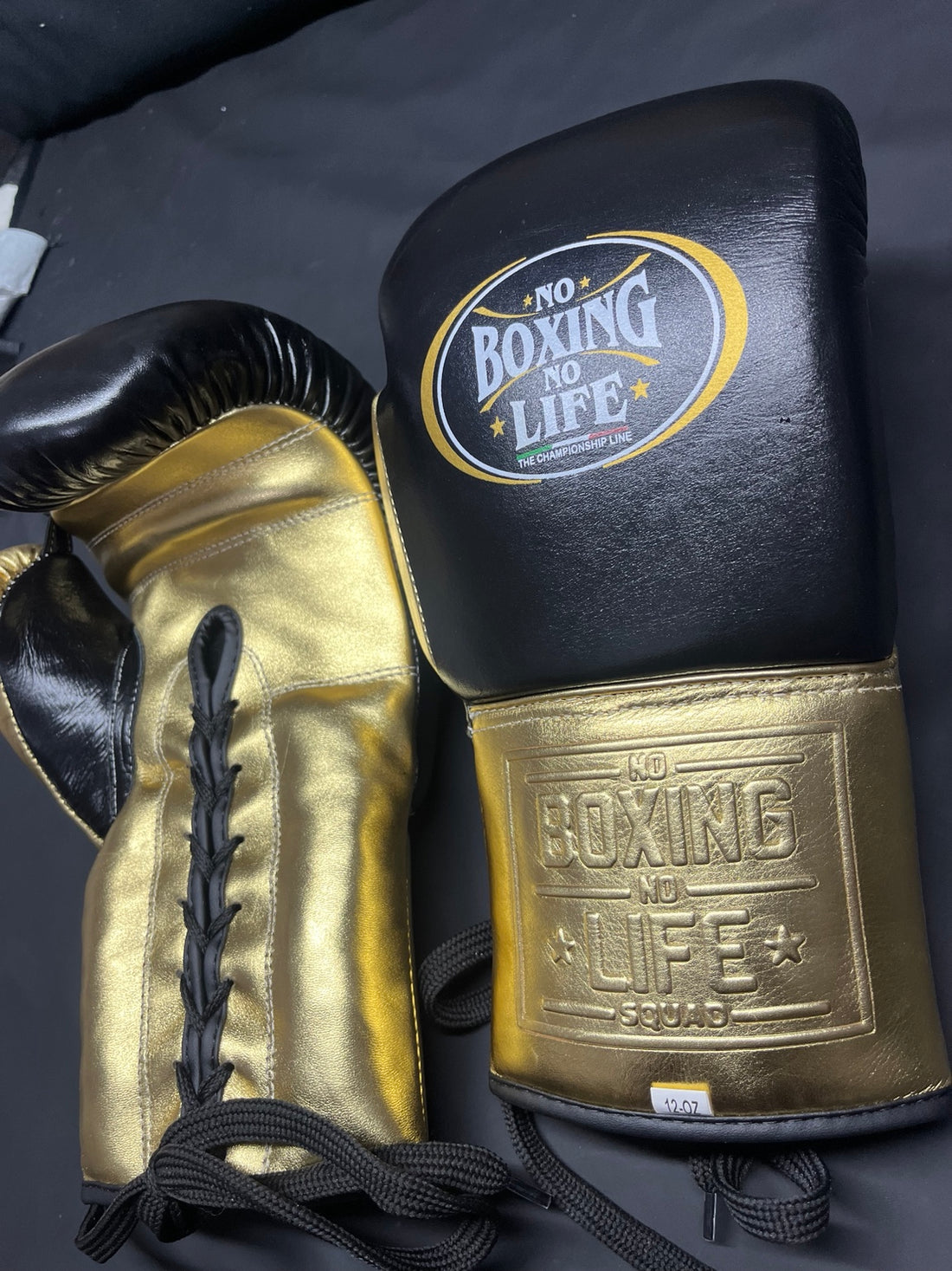 No Boxing No Life black and gold lace-up boxing gloves side view