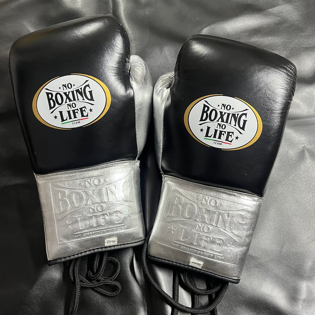 No Boxing No Life black and metallic silver lace-up boxing gloves front pair view