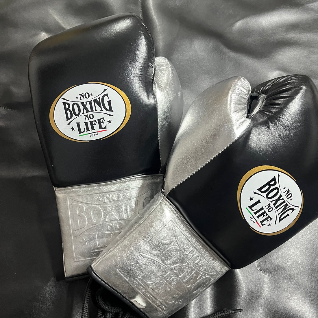 No Boxing No Life black and metallic silver lace-up boxing gloves angled view