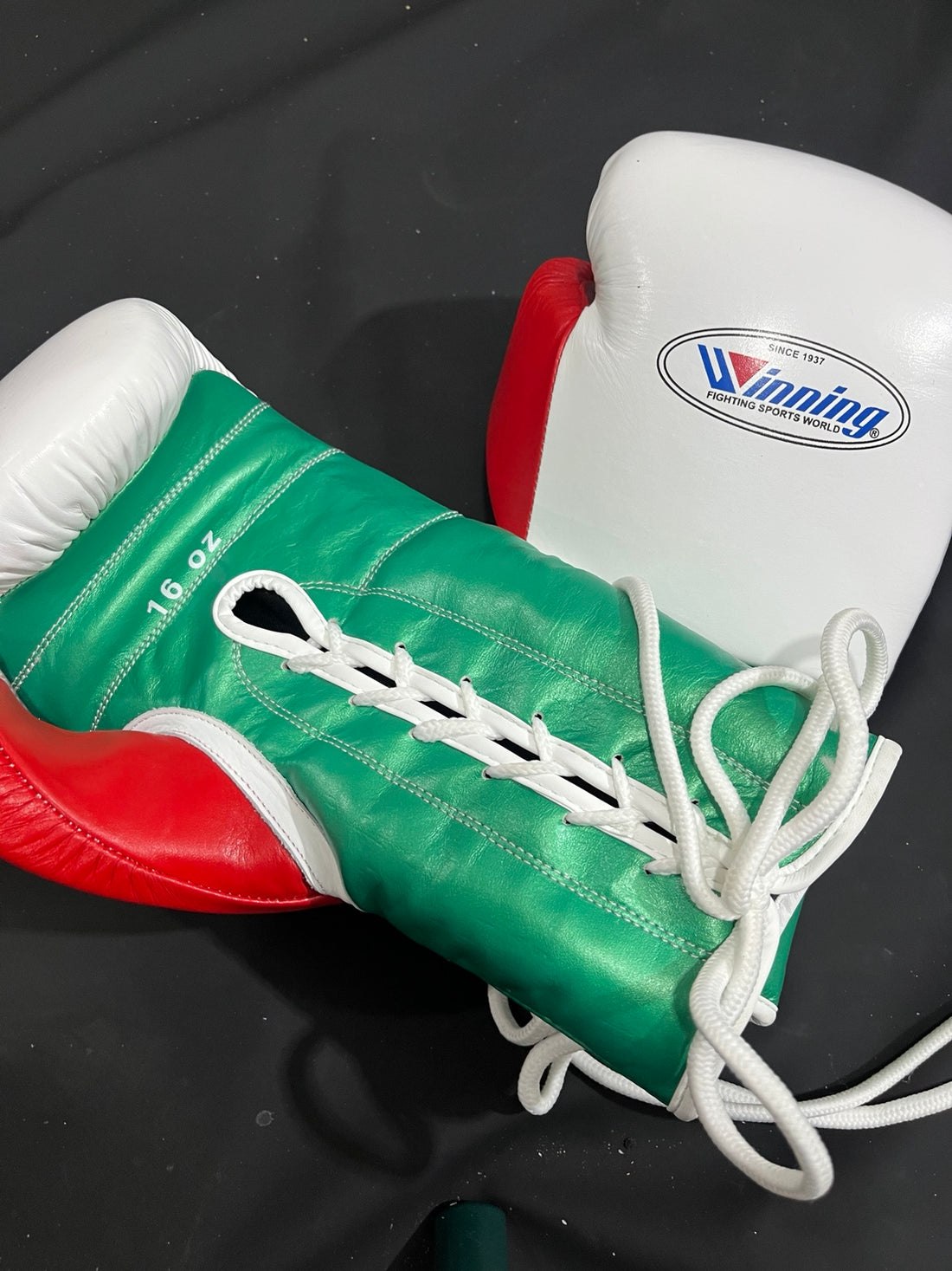 Winning white green and red lace-up boxing gloves palm and lacing view