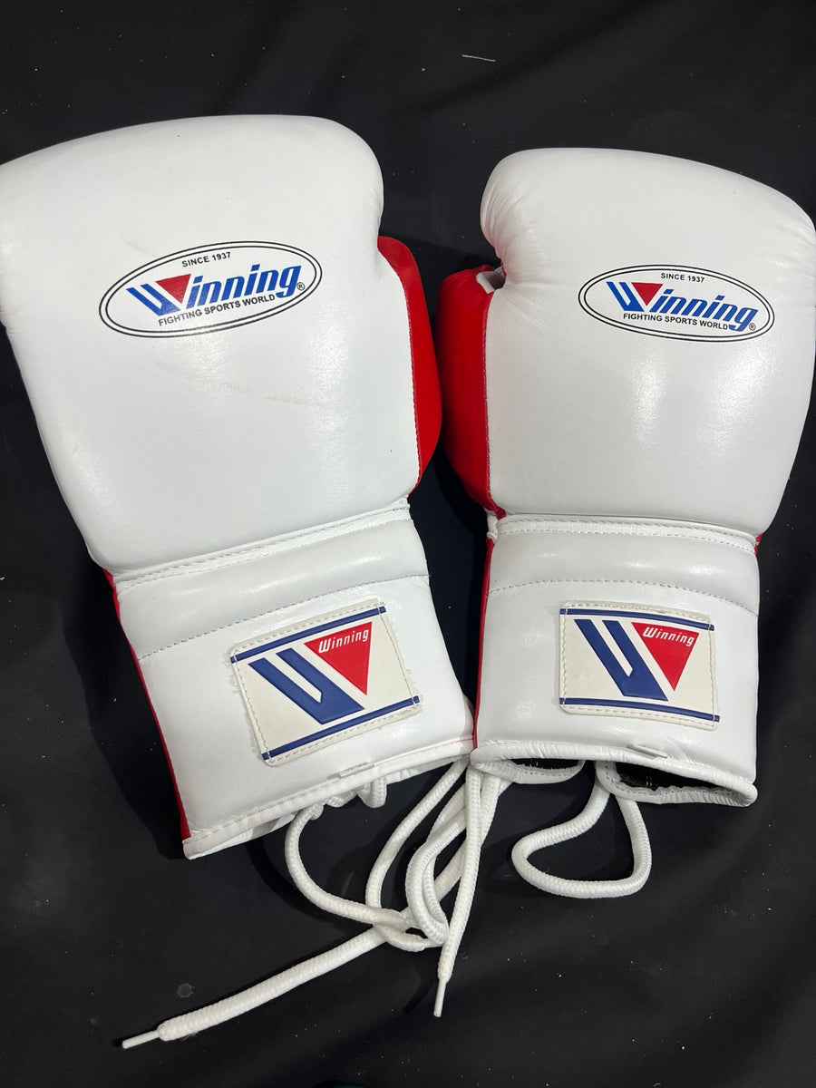 Pair of Winning white and red lace-up boxing gloves