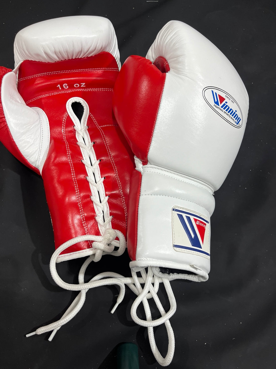Winning white and red 16 oz lace-up boxing gloves palm and lacing view